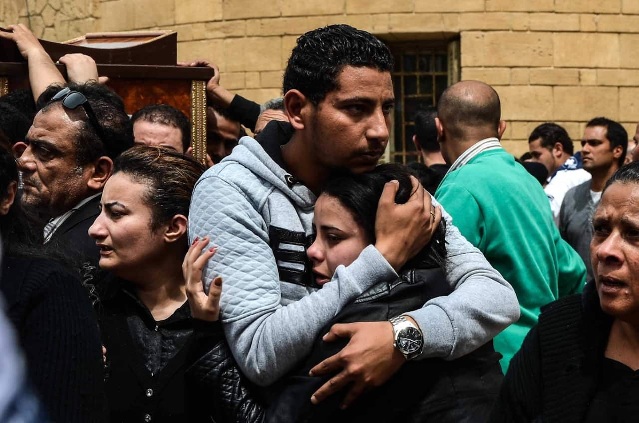 Relatives react during the funeral of Copts on April 10 (AAP)