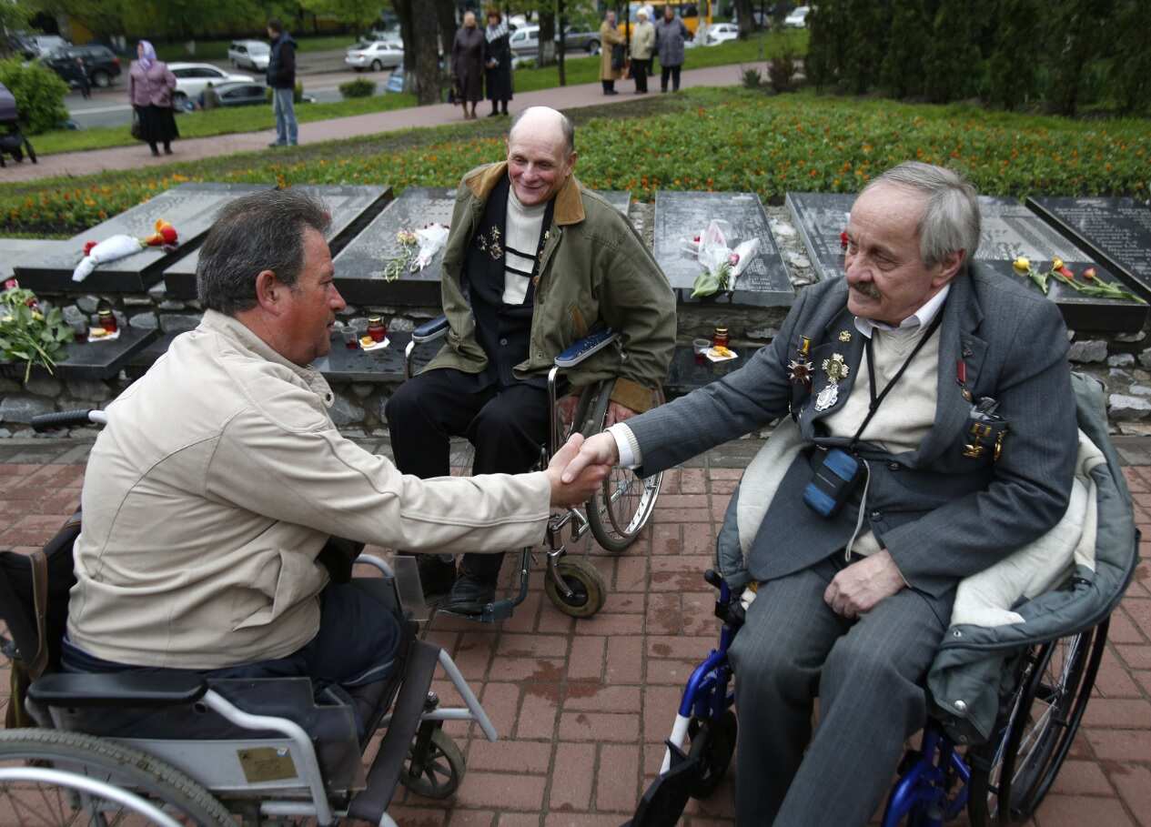 Former liquidators of the Chernobyl nuclear accident in wheelchairs attend a commemoration ceremony (Getty)