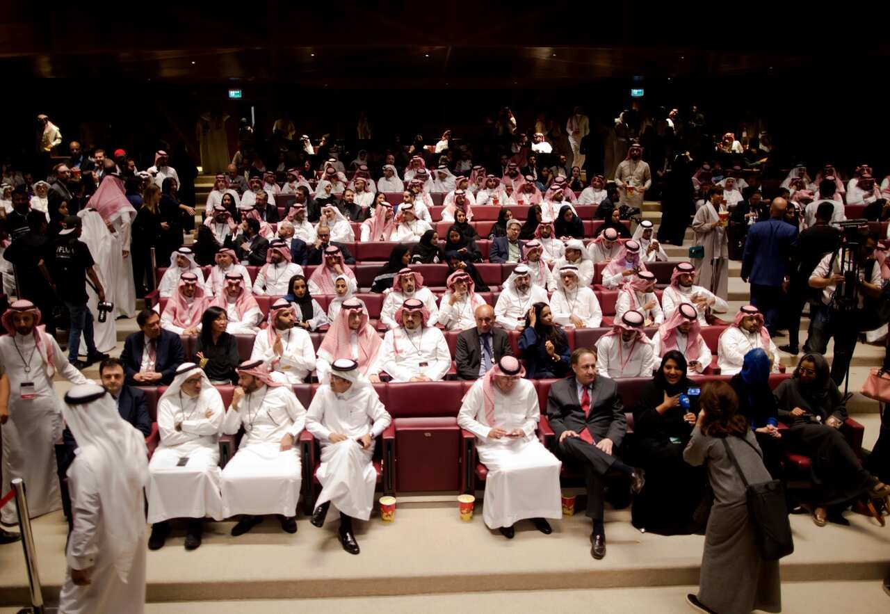 Visitors attend a cinema theatre during an invitation-only screening, at the King Abdullah Financial District Theater
