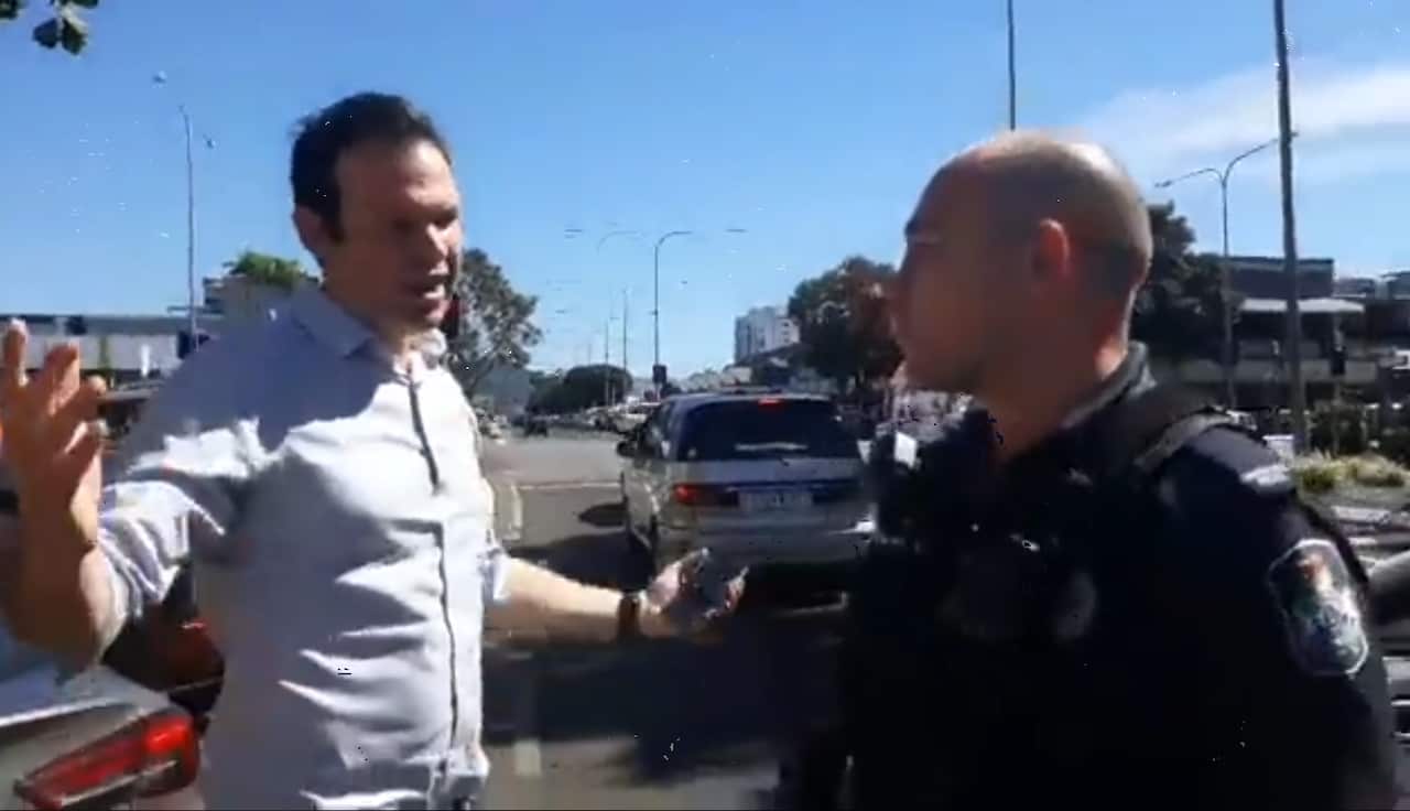 Resources Minister Matt Canavan speaks with police after being confronted by climate activists.