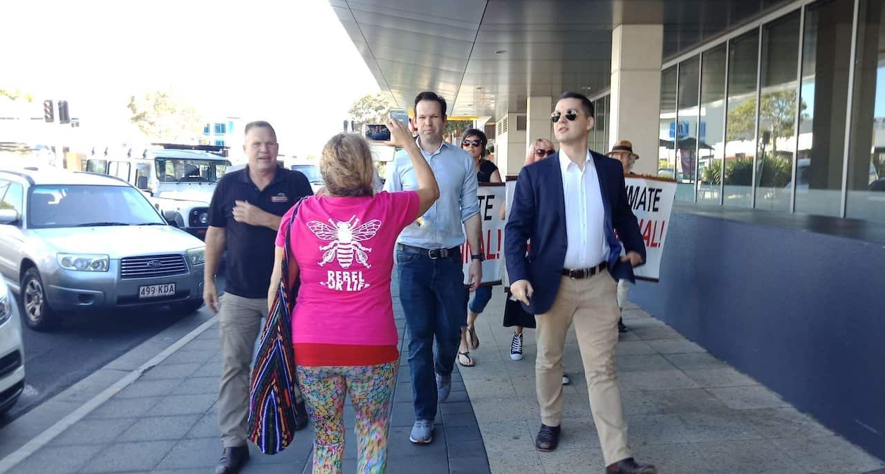 Matt Canavan is followed by Extinction Rebellion protesters as he makes his way to a car.