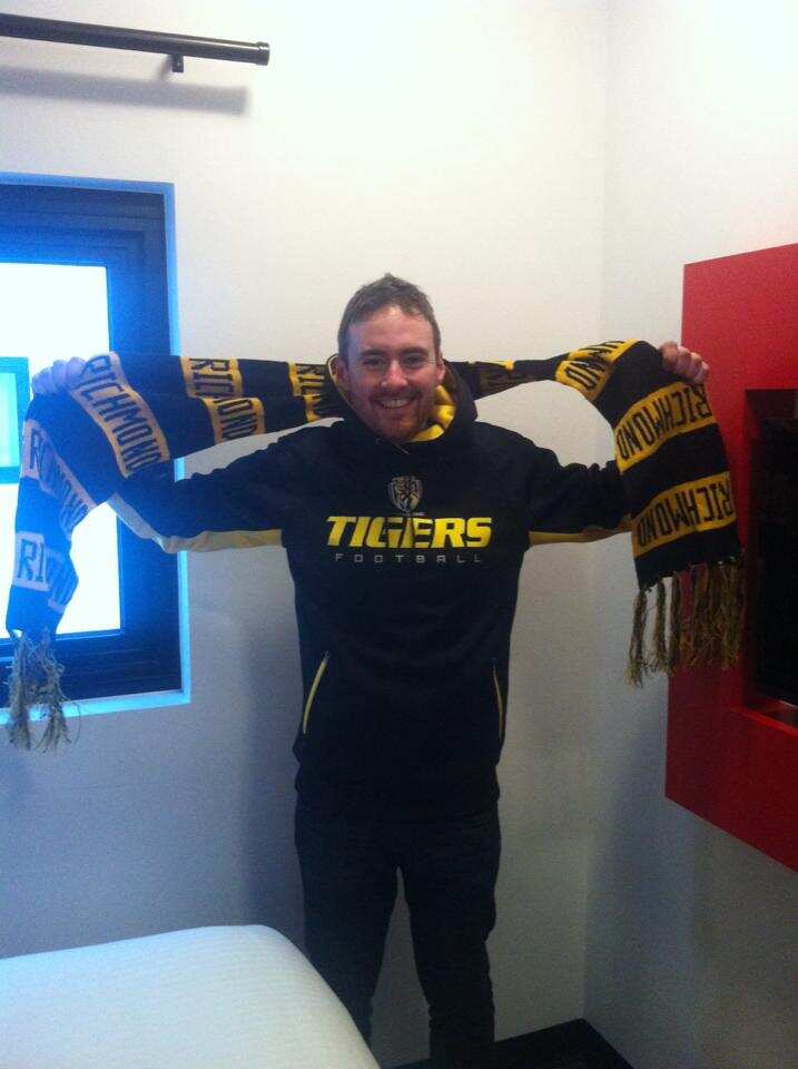 Peter Moloney poses with Richmond Tigers supporter gear