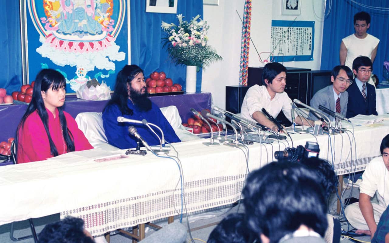 AUM Shinrikyo leader Shoko Asahara (2nd L) attends a press conference after some of facilities have been raid by police on October 25, 1990 in Tokyo, Japan.