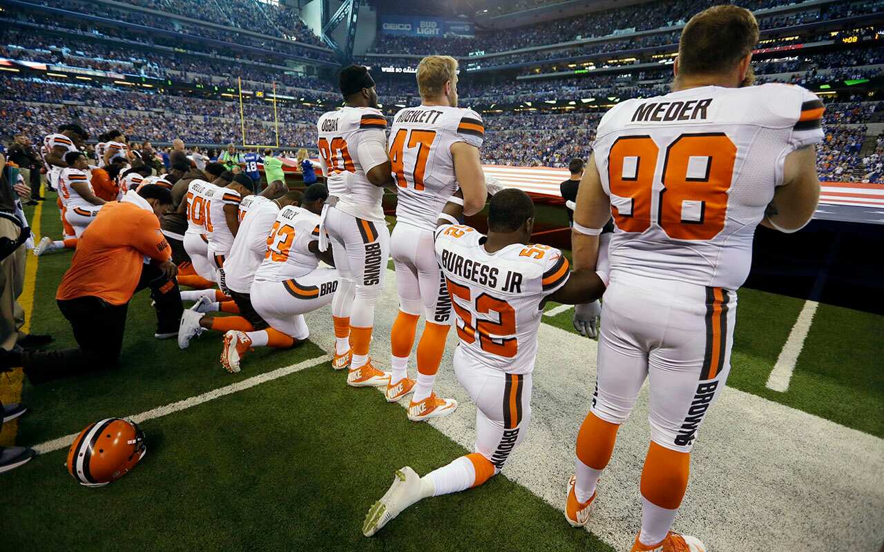 Members of the Cleveland Browns take a knee during the national anthem before game against the Indianapolis Colts.