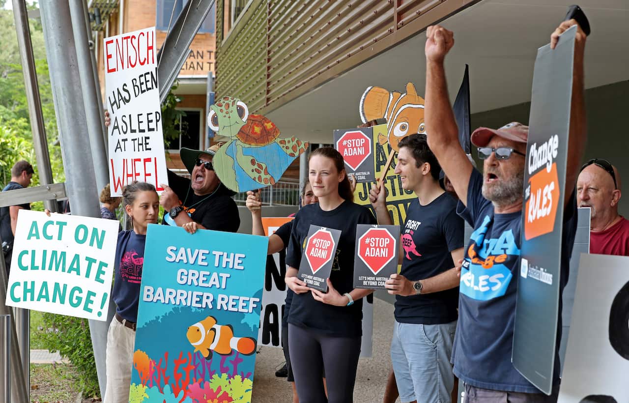 A group of protesters greets Australian Prime Minister Scott Morrison during a visit to the Australian Institute of Tropical Health.