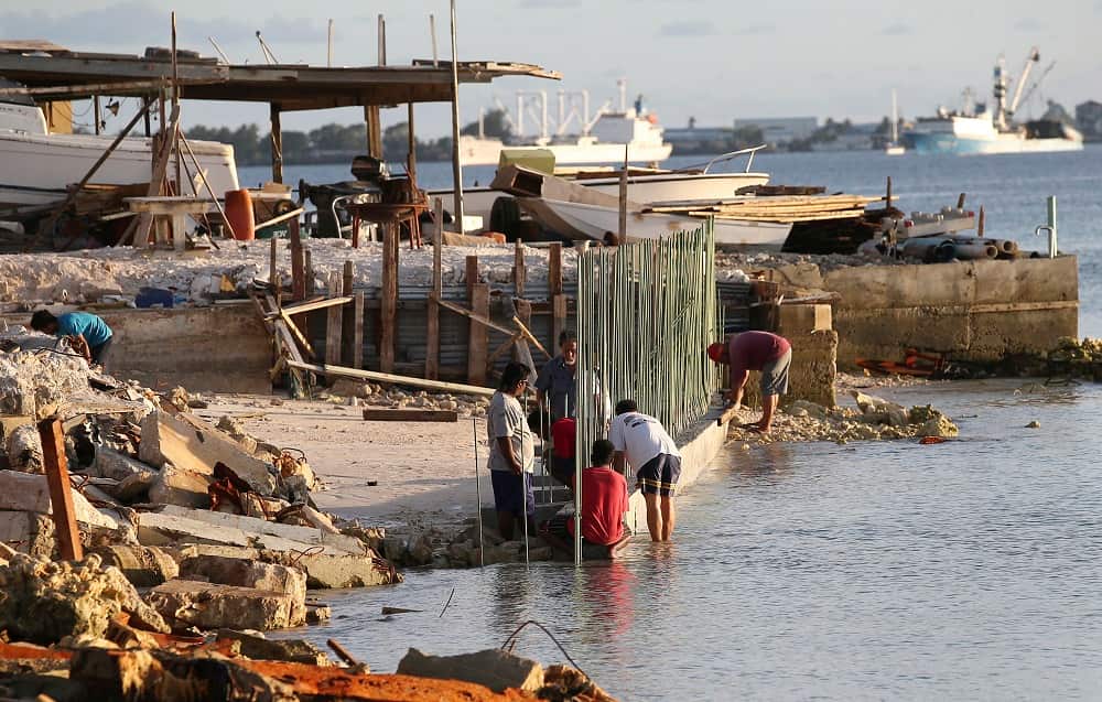 In this Nov. 5, 2015 file photo, workers build a sea wall on Majuro Atoll  in the Marshall Islands.  
