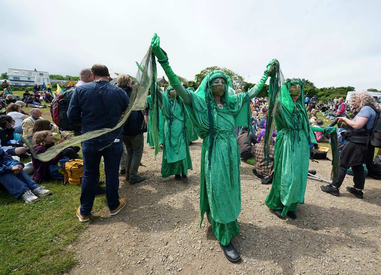 Climate activists demonstrate near the G7 meeting taking place in St. Ives, Cornwall, England.