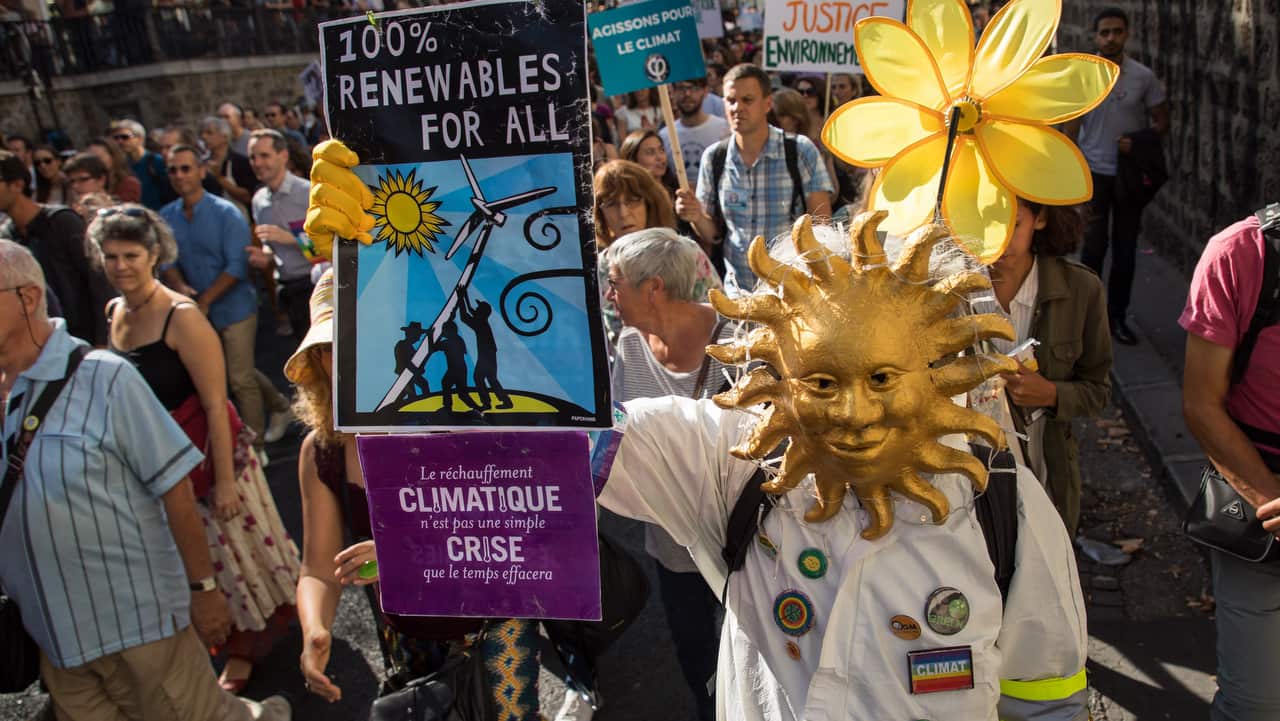An environmental activist walks during the 'March for the climate', in Republic square, Paris, France.