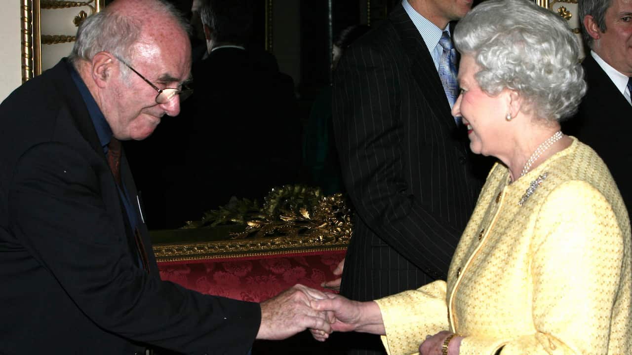 Queen Elizabeth greets Australian author Clive James at Buckingham Palace in 2006.  