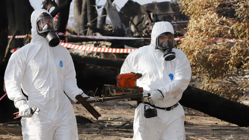 ATSB Transport Safety Investigators retrieving the Cockpit Voice Recorder from the wreckage of the C-130 Hercules air tanker plane that crashed.