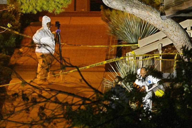 Forensic officers work at the scene of the mass shooting.