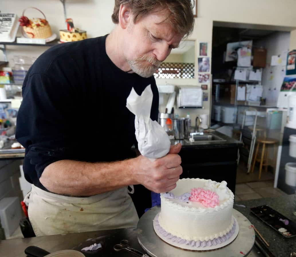 File photo, Masterpiece Cakeshop owner Jack Phillips decorates a cake inside his store in Lakewood