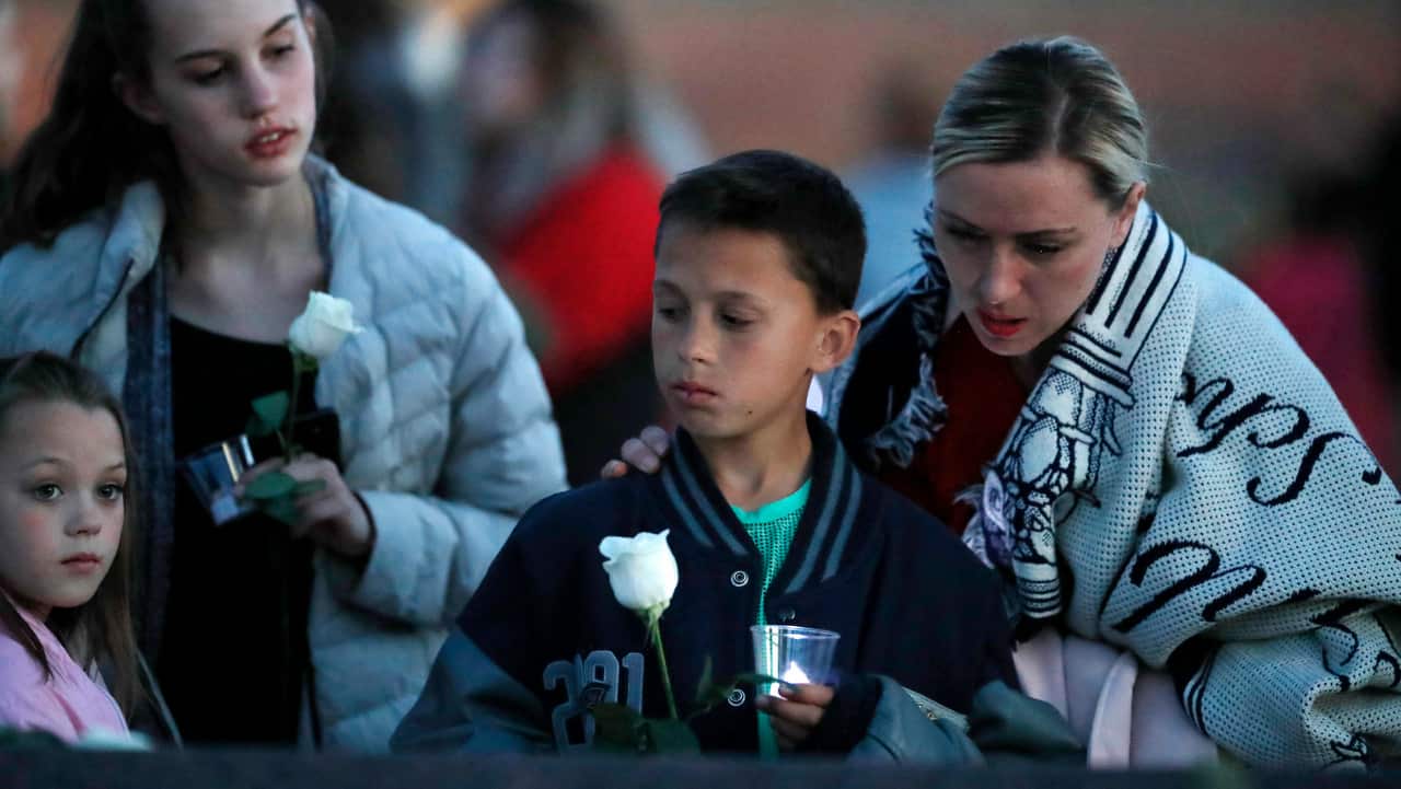 A vigil at the memorial for the victims of the massacre at Columbine High School.