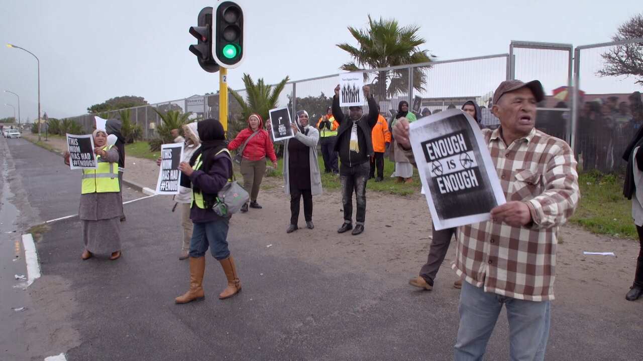 Parents protest violence outside the local school.