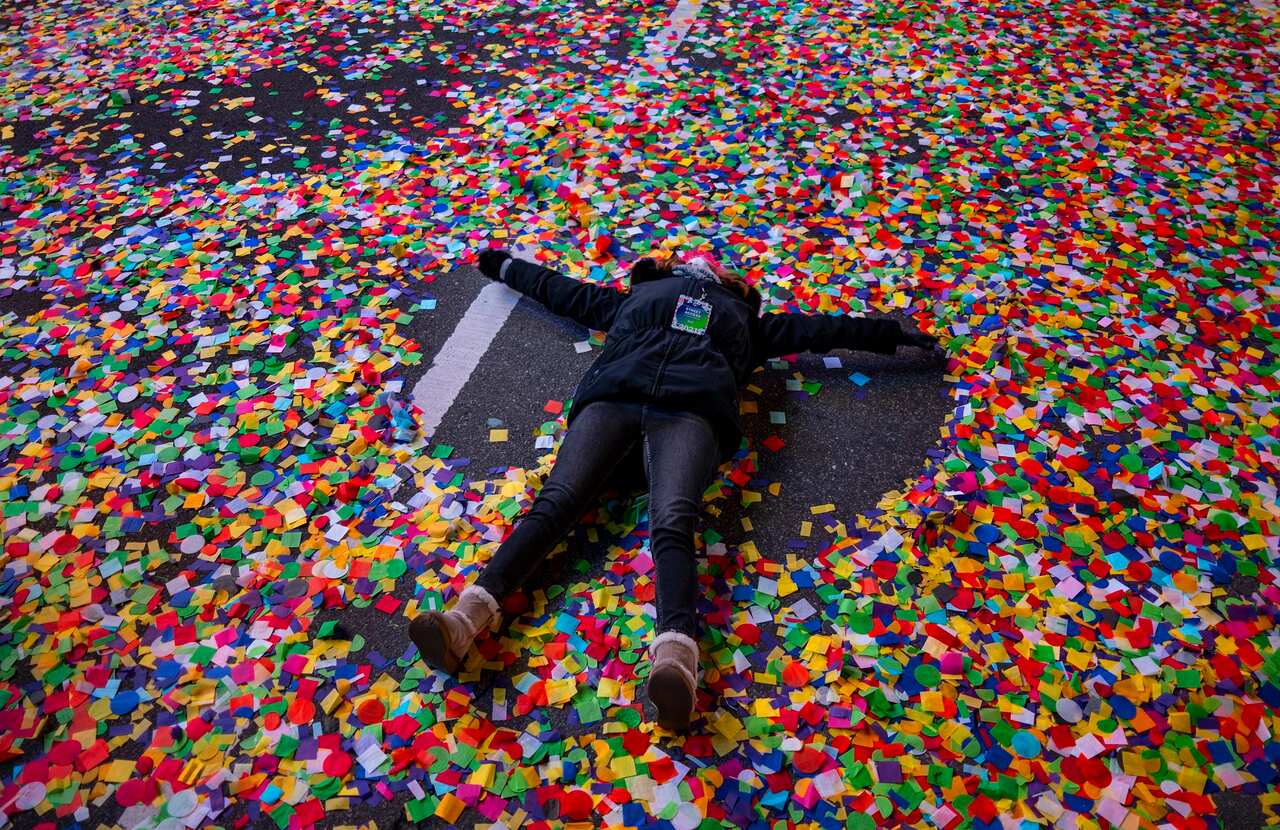 Jaclyn Bernstein of New York lays in the confetti after the Times Square New Year's Eve Ball dropped in Times Square.