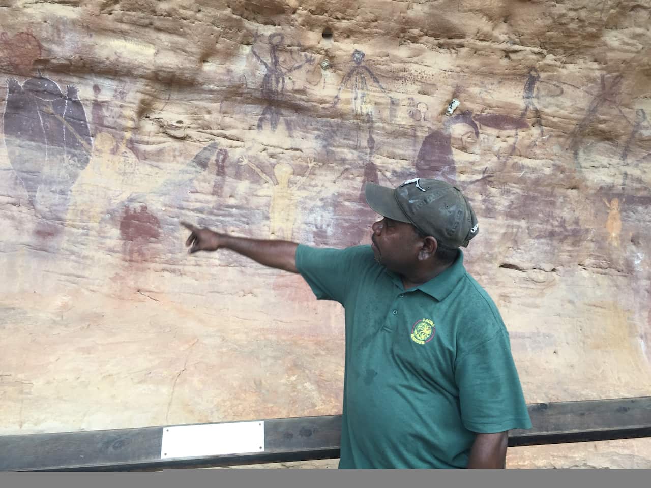 Ranger Trevor Bramwell points to rock paintings at Split Rock near the Cape York town of Laura.