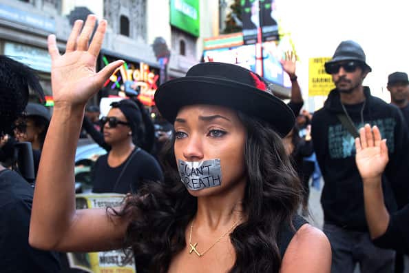 People march in response to the ruling no charges will be brought against the officer involved in the Eric Garner case.