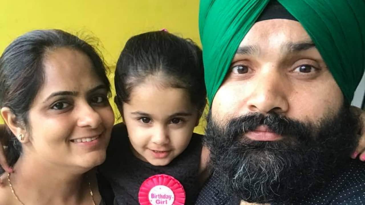Gurpreet Singh, who is trapped in India, with his wife and daughter. 