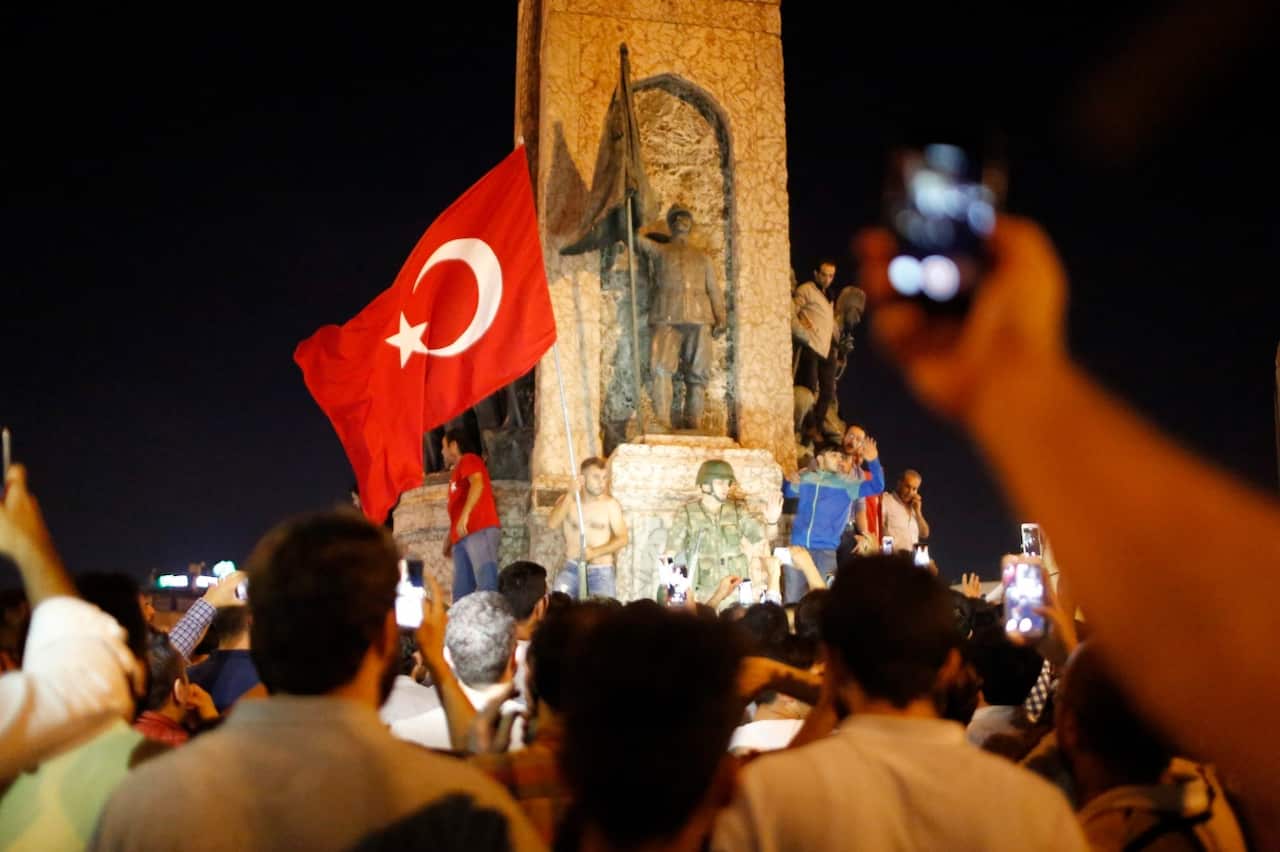 Supporters of President of Turkey Recep Tayyip Erdogan shout slogans at the Taksim Square in Istanbul, Turkey, 16 July 2016.