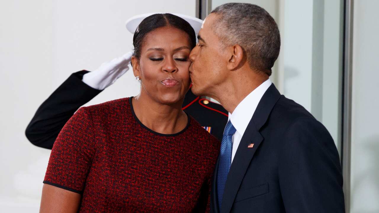 President Barack Obama is pictured kissing first lady Michelle Obama on January 20, 2017.