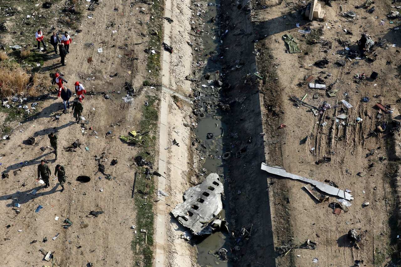 Rescue workers search the scene where a Ukrainian plane crashed in Shahedshahr, southwest of Tehran, Iran on 8 January, 2020.