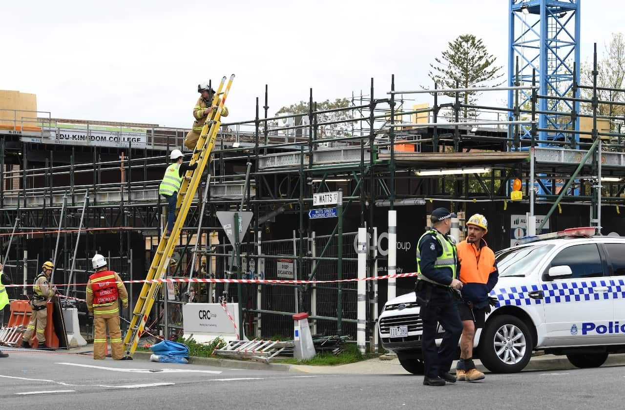Emergency service workers and police are seen at the scene of an accident at a construction site in Box Hill