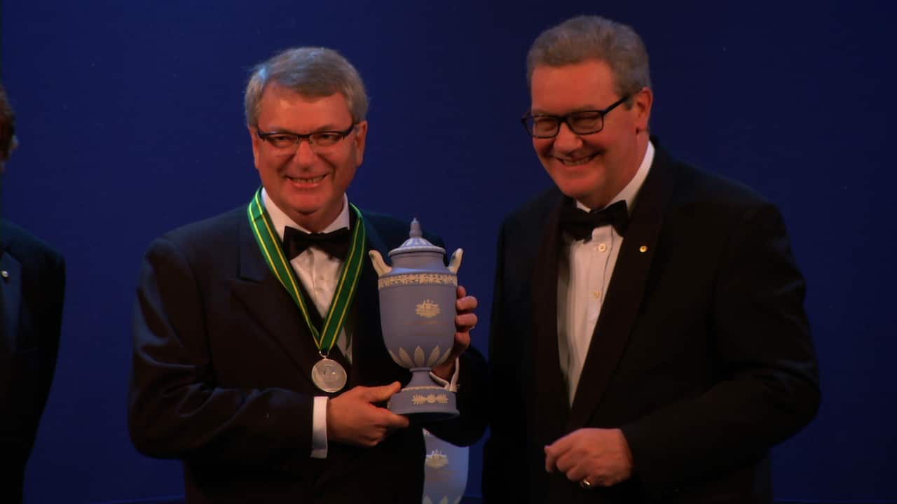 Sir Lynton Crosby receives his Australian of the Year in the United Kingdom award from High Commissioner Alexander Downer.