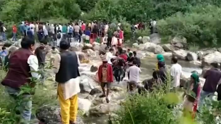 Crowds gather near the crash site of the Indian bus in a mountainous region of Himachal Pradesh state.