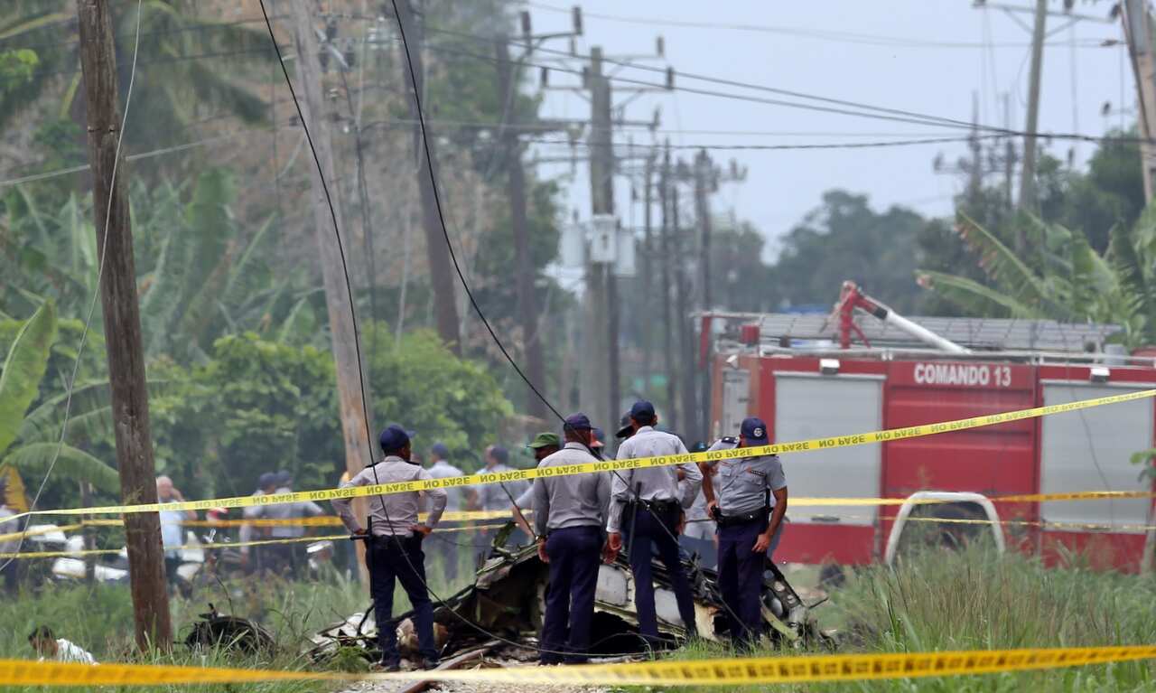 Policemen and soldiers guard the wreckage of the Boeing-737 that crashed shortly after take off at the Jose Marti International Airport in Havana, Cuba