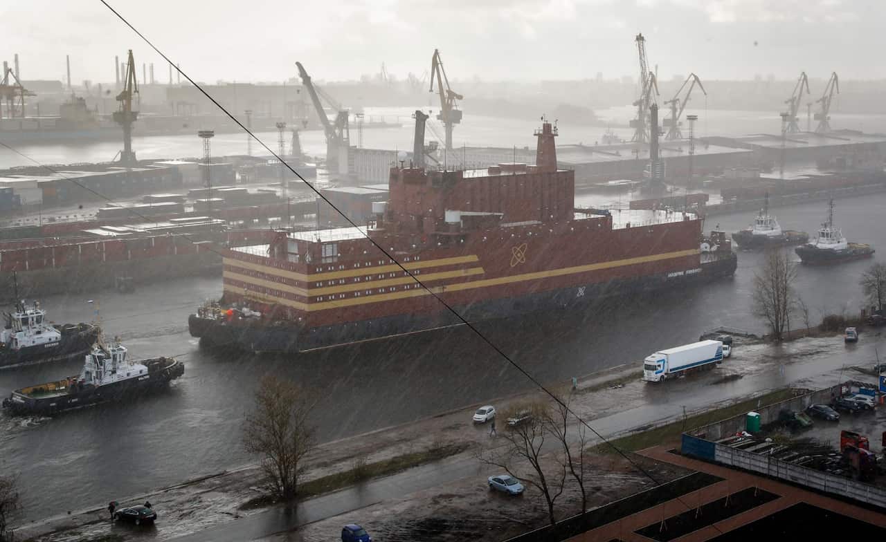 The floating nuclear power plant, the 'Akademik Lomonosov', is towed out of the St. Petersburg shipyard