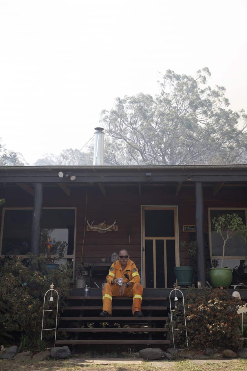 Volunteer firefighter Mark Tull has a cup of tea after saving a house.