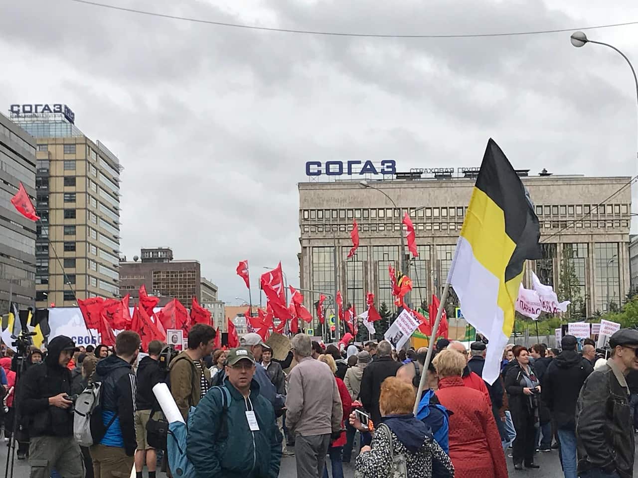 Protesters wave flags according to their political affiliation