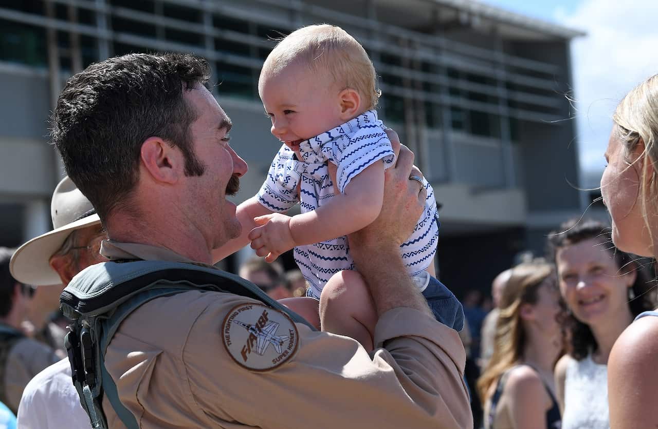  Pilot from No.1 Squadron, is greeted by his family after landing Super Hornet strike aircraft at the RAAF Base Amberley, west of Brisbane.
