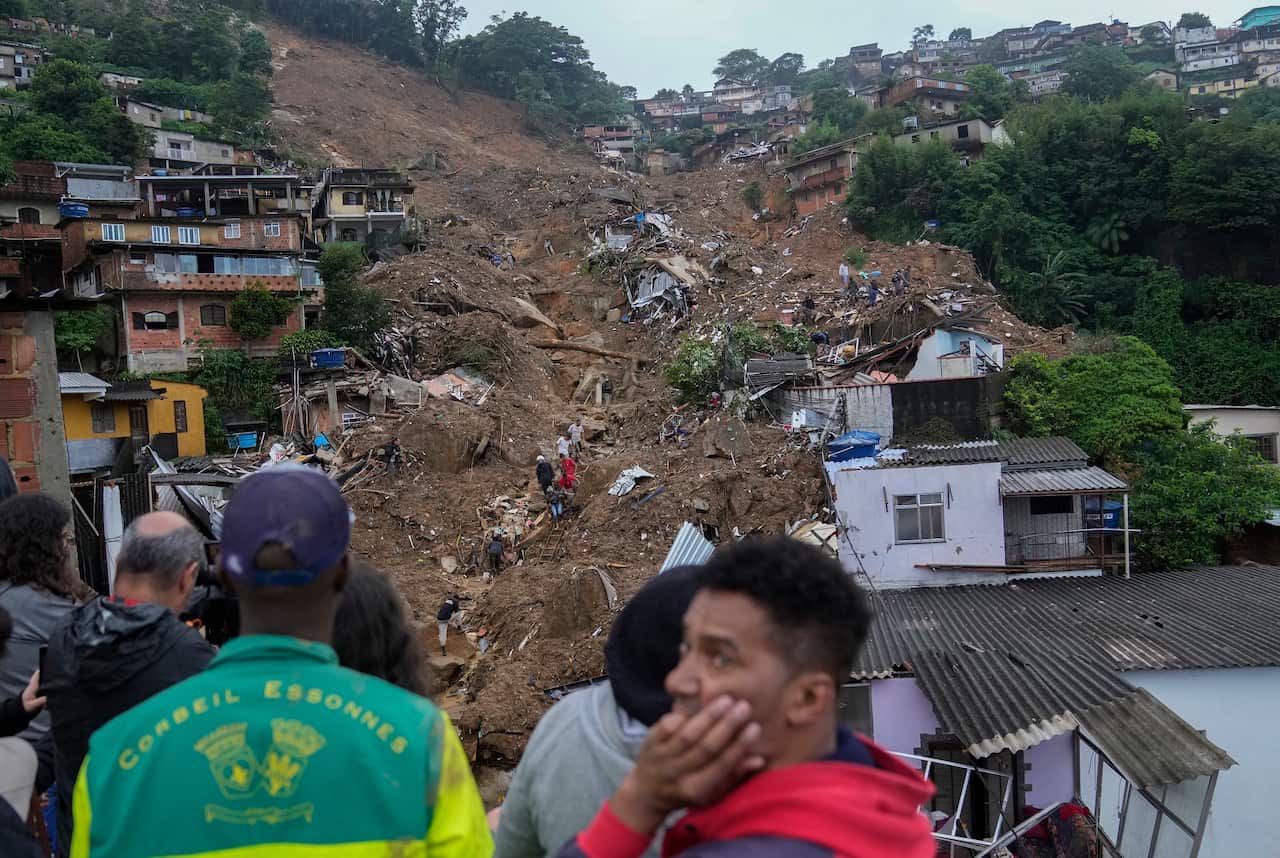 Rescue workers and residents look for victims  in an area affected by landslides in Petropolis.