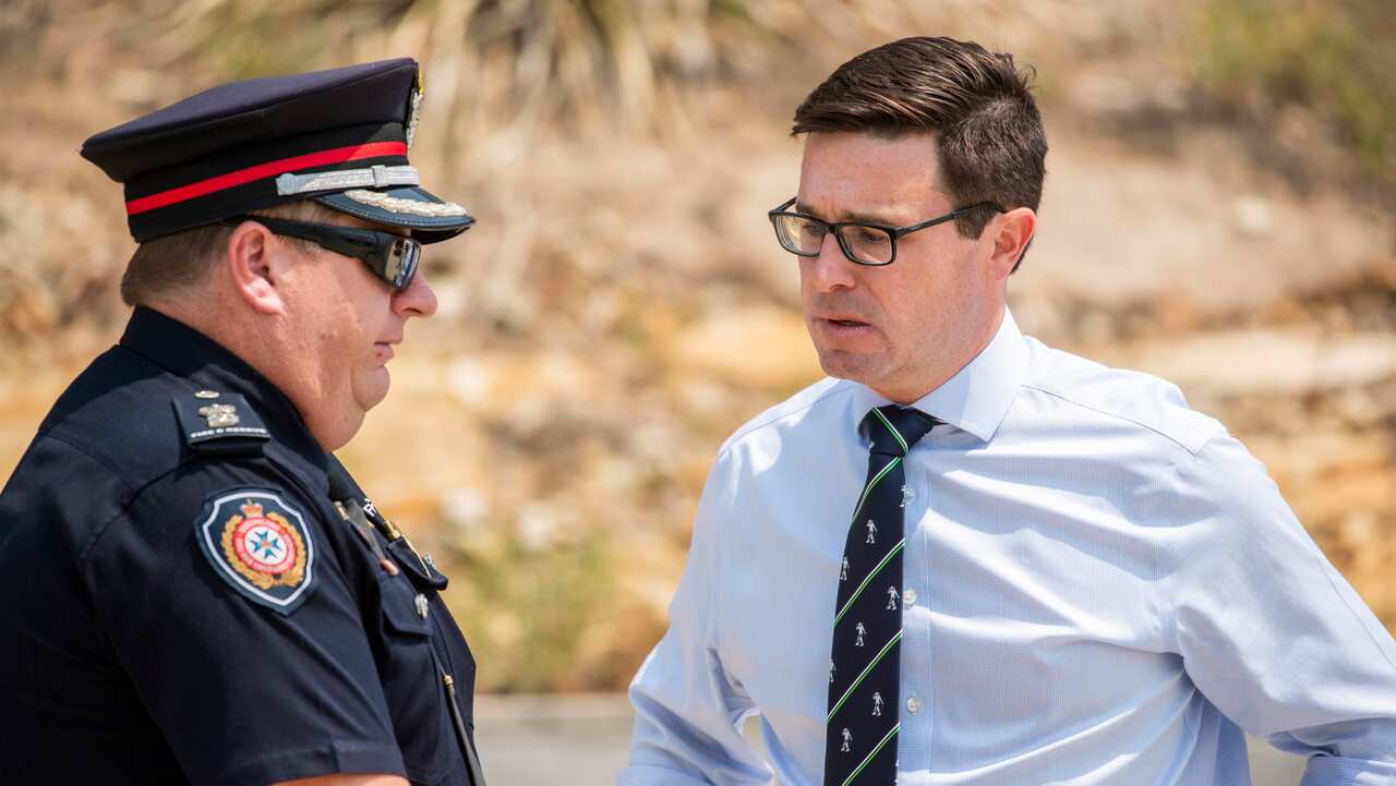 Minister for Natural Disaster and Emergency Management David Littleproud (right) speaks Superintendent Tyson Loetzsch at Ripley Fire Station in Ipswich.