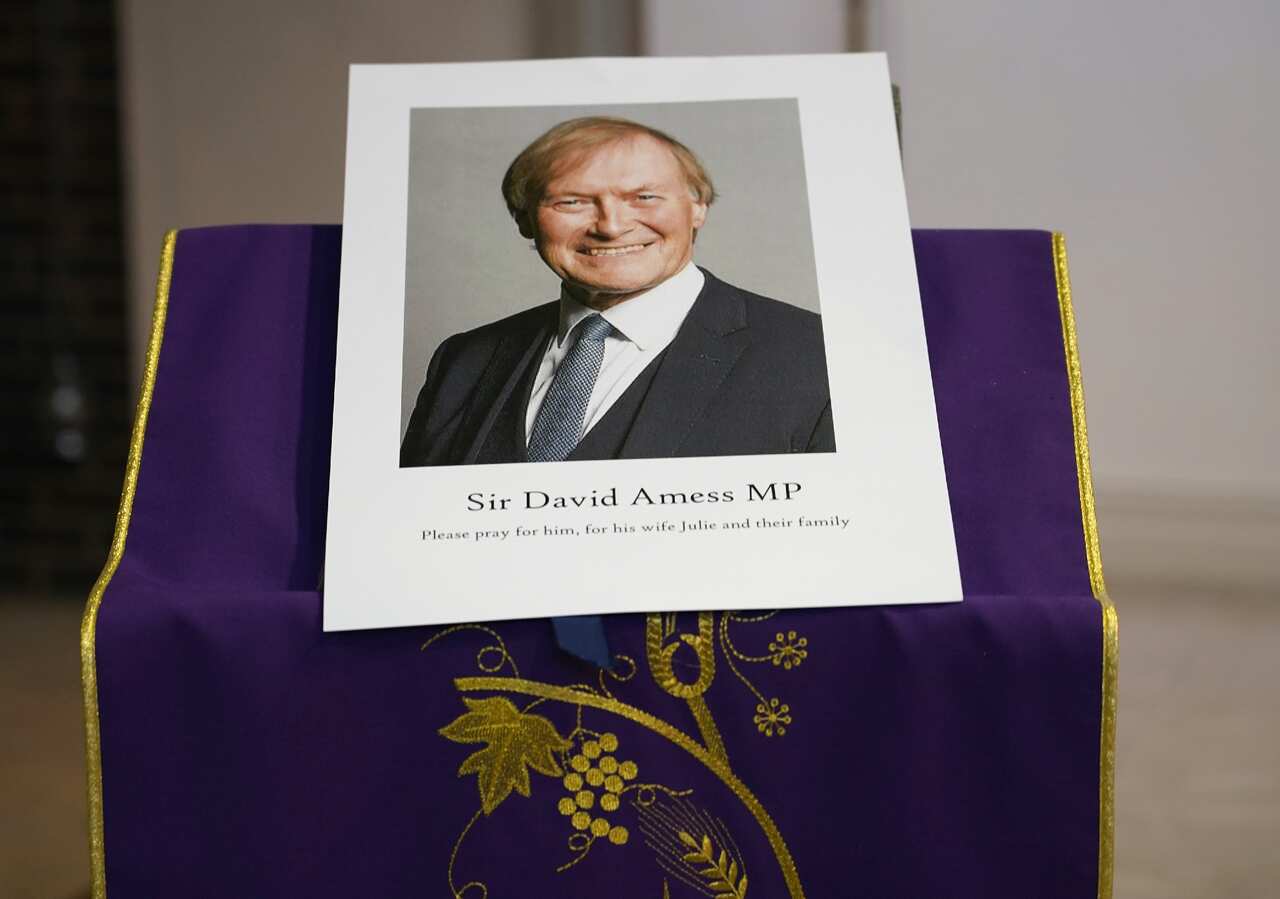 An image of murdered British Conservative lawmaker David Amess is displayed near the altar in St Peters Catholic Church at a vigil in Leigh-on-Sea, Essex.
