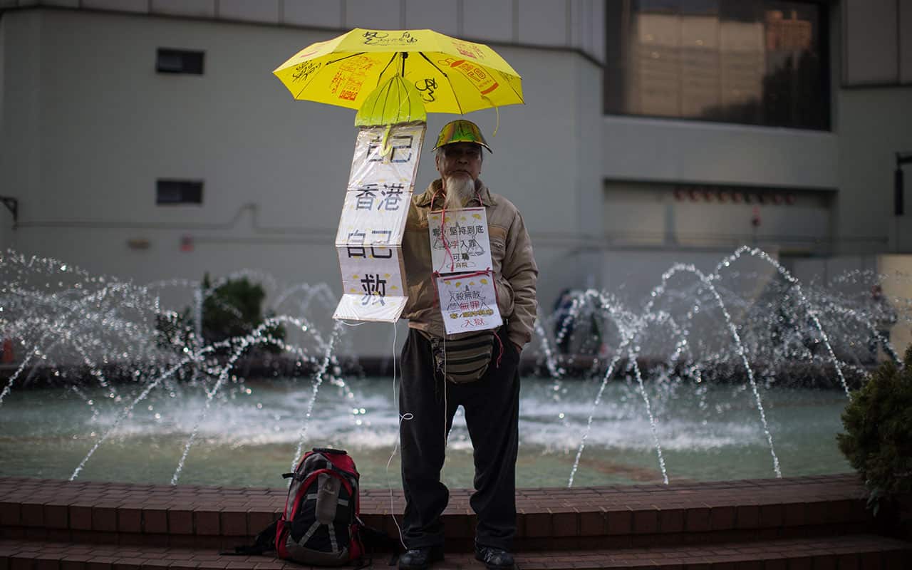 A pro-democracy supporter holds a yellow umbrella and stands outside the High Court in Hong Kong, China, 17 January 2018.