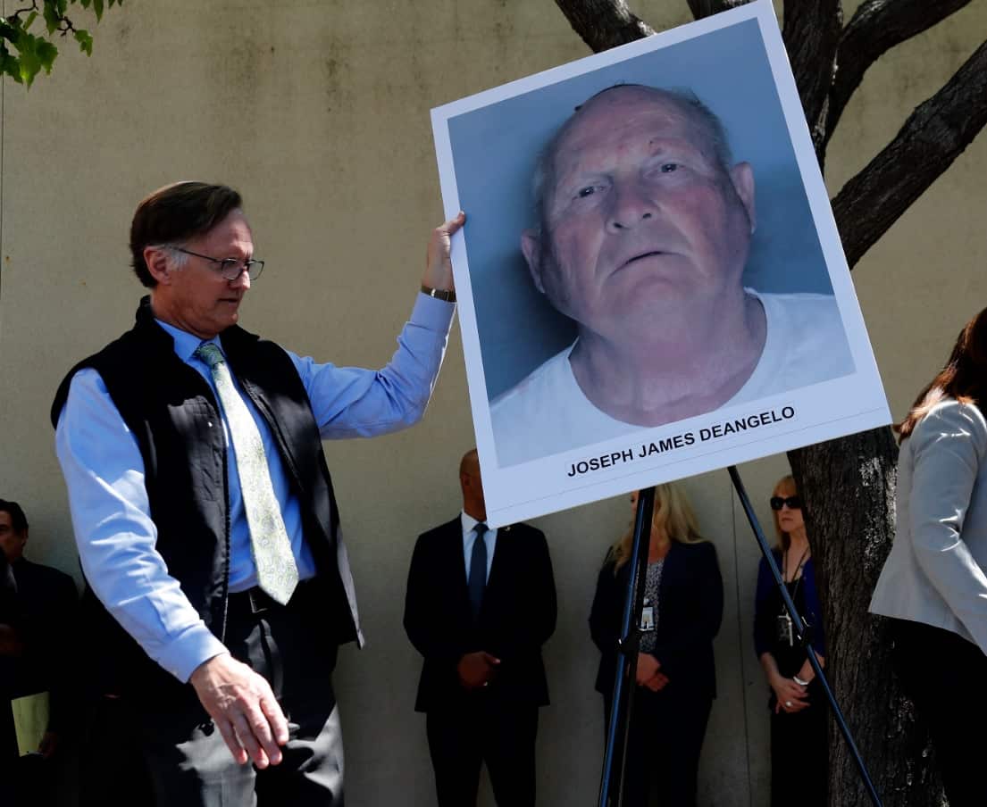 An official puts a mug shot on an easel stand, of the suspect identified as Joseph James DeAngelo, 72, a former police officer in Visalia and Auburn