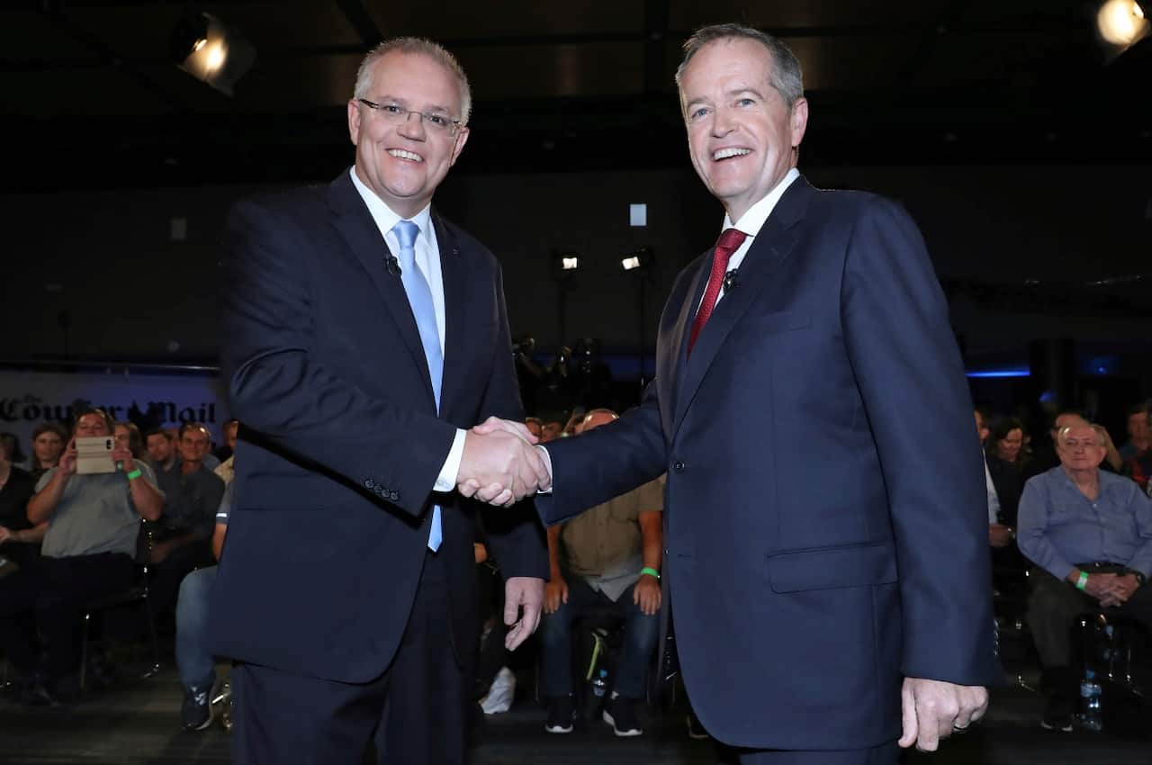 Australian Prime Minister Scott Morrison, left, and opposition leader Bill Shorten shake hands before the Sky News/Courier Mail People's Forum in Brisbane.