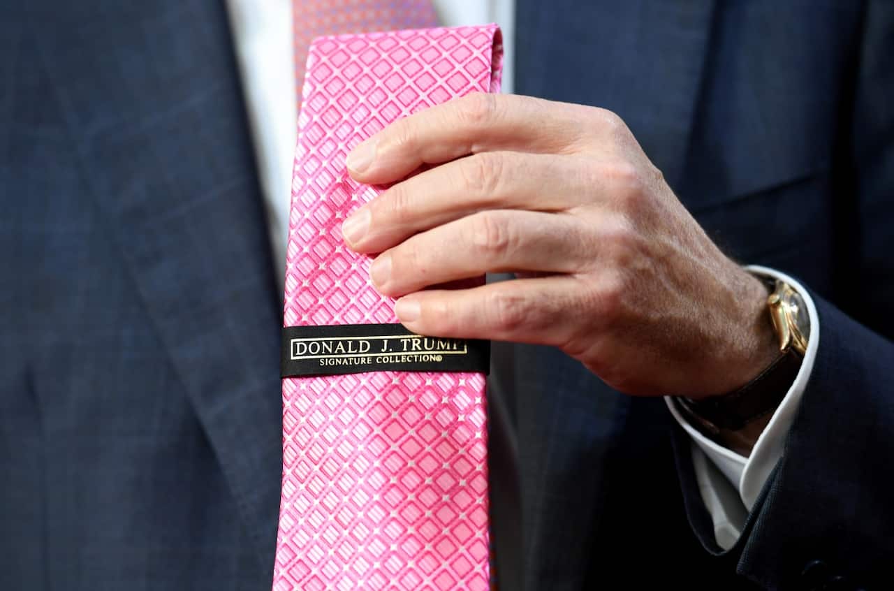 Prime Minister Malcolm Turnbull holding up the tie (AAP)