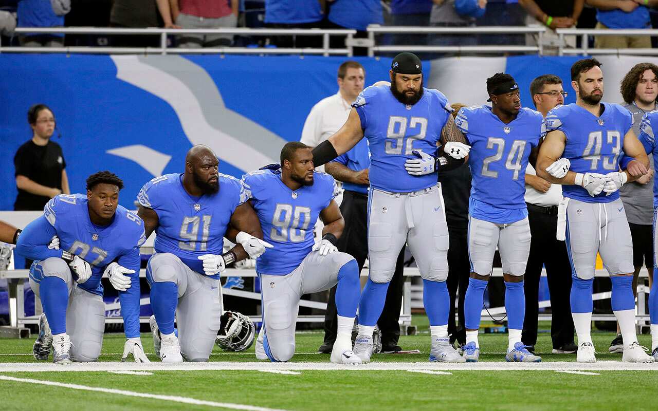 Detroit Lions Armonty Bryant, A'Shawn Robinson and  Cornelius Washington take a knee before game against the Atlanta Falcons.