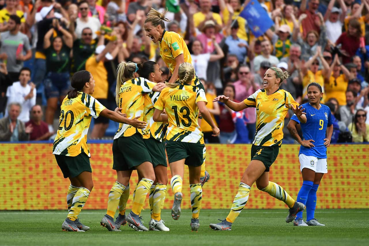 Matildas players celebrate post-match.