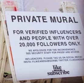 The sign actually calls for people to follow an account called 'Like and Subscribe' on Twitter and Instagram