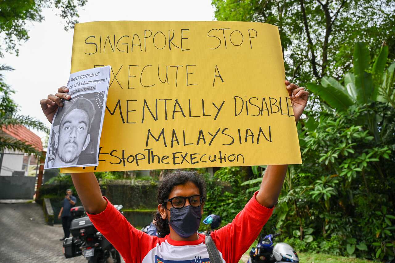 An activist in Kuala Lumpur holds a poster in protest of the execution of Nagaenthran K Dharmalingam.