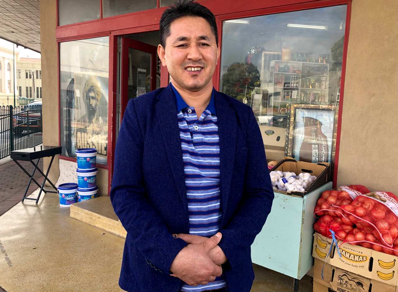 Didar outside his shop
