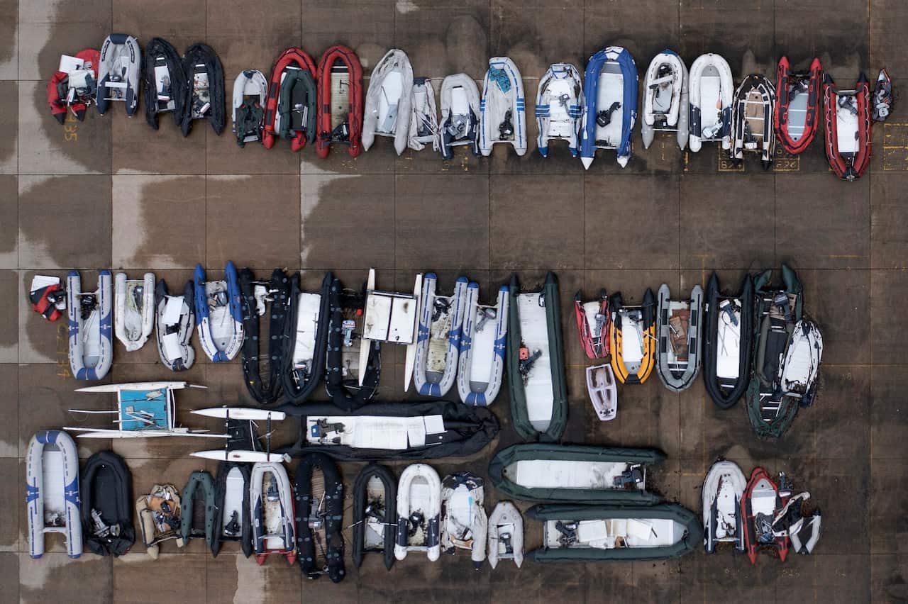 Dinghies used by migrants to cross the channel, are stored at a facility in Dover, England. 