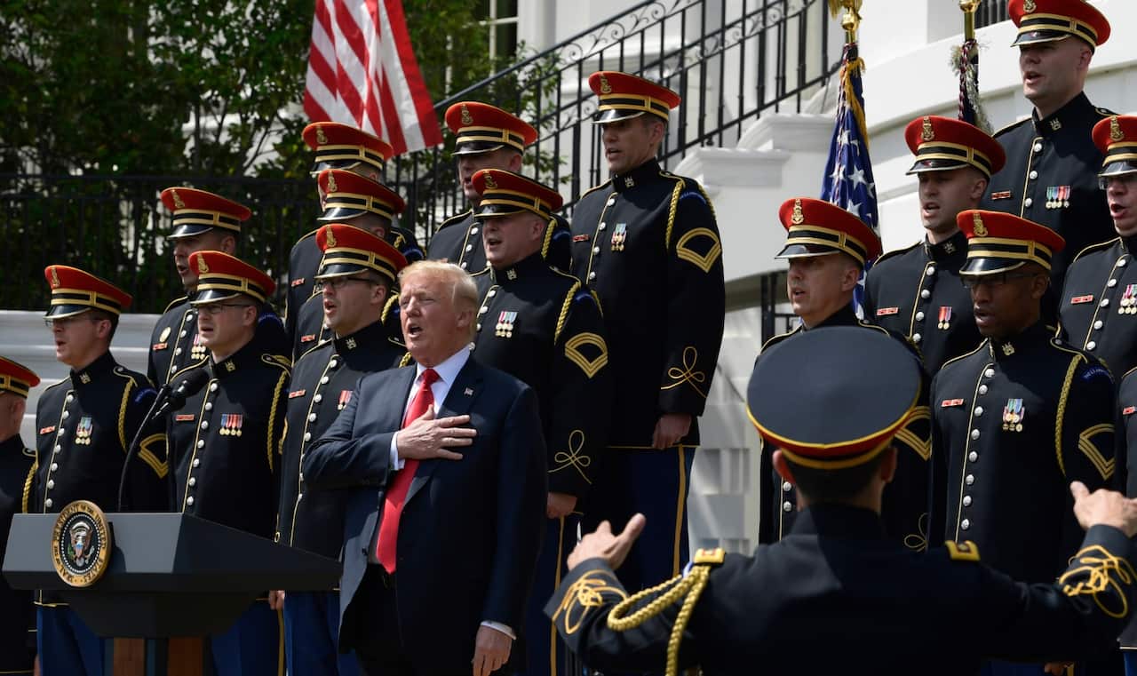 President Donald Trump sings the National Anthem during a "Celebration of America" event