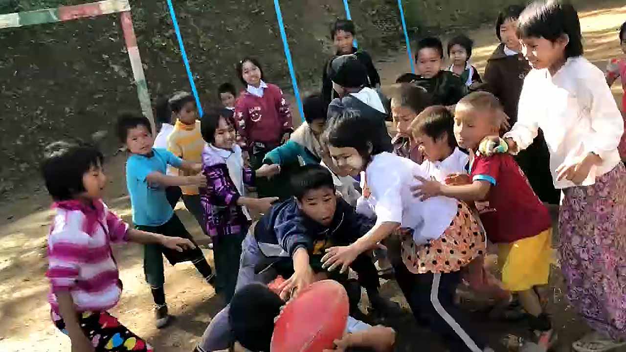 Children from Myanmar's Chin State discover the wonders of the oval ball.