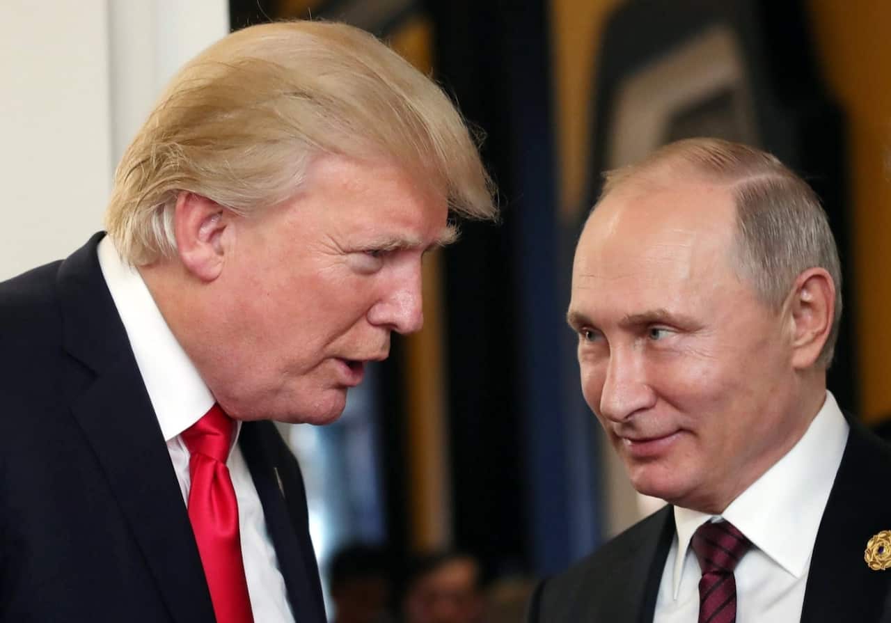 Russian President Vladimir Putin (R) and US President Donald J. Trump (L) talk at the break of a leader's meeting at the 25th Asia-Pacific Economic Cooperation