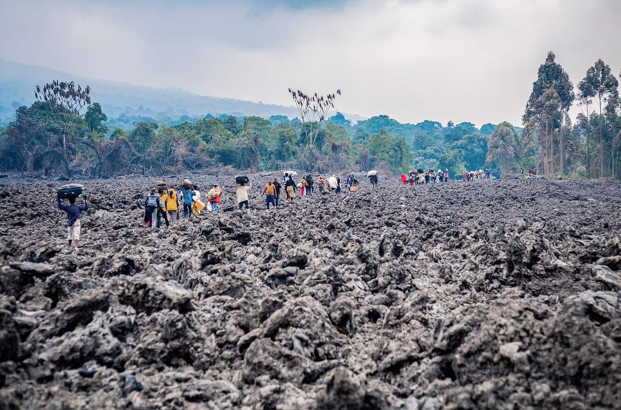 Congolese are evacuated across cooled lava from the town of Goma in the aftermath of Mount Nyiragongo volcano over Goma.